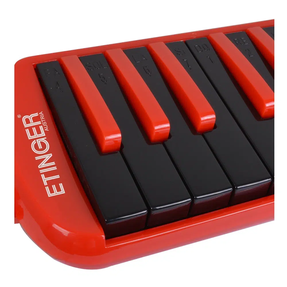 Close-up of a red compact piano keyboard with black keys and red keytops, angled for a dynamic look.
